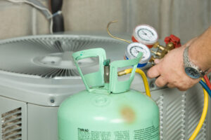 FAQs About New AC Regulations gauges - Man checks AC Unit.