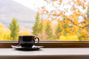 a cup o tea in front of a window with autumn view, why do i need a humidifier in the fall?